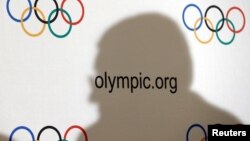 FILE - International Olympic Committee (IOC) President Thomas Bach casts a shadow during a news conference after an Executive Board meeting in Lausanne, Switzerland, Dec. 8, 2016. 