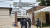 Police officers walk out of premises of the Autonomous National Electoral Commission (CENA) as counting of votes begins in Cotonou, on Apr. 12, 2021. 