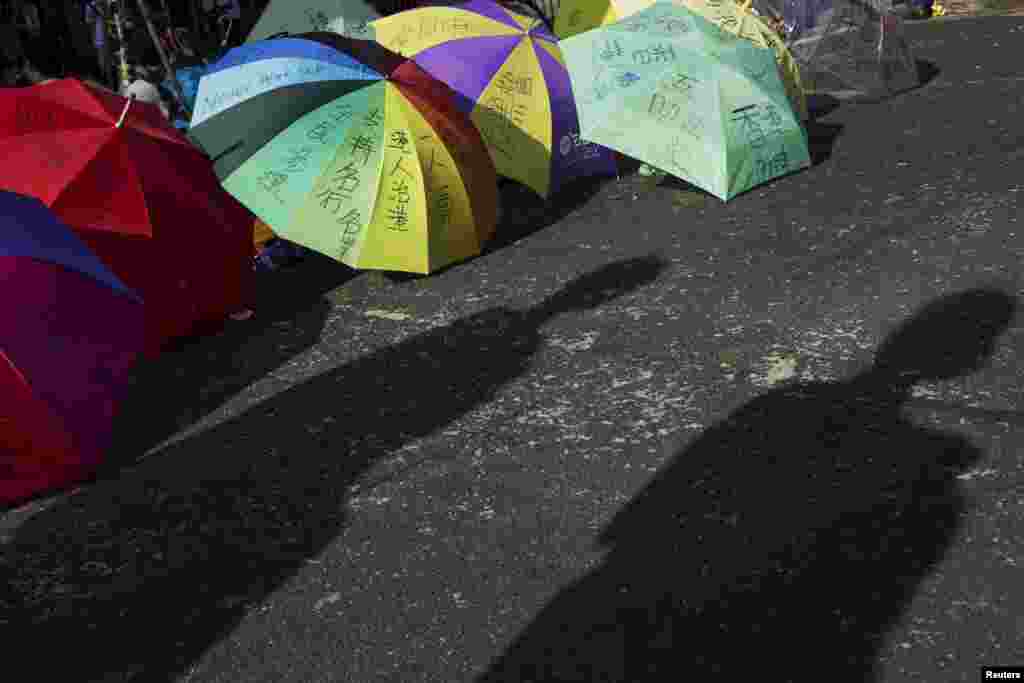 Umbrellas belonging to protesters of the Occupy Central movement lie on a main road at the Mong Kok shopping district in Hong Kong, Oct. 6, 2014.