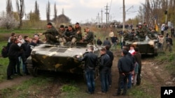 People block a column of Ukrainian Army combat vehicles on their way to the town of Kramatorsk on April 16, 2014. 