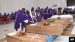 FILE: Mourners pay theirs respects to the victims killed at the St. Francis Catholic Church on June 5, during a funeral service in Owo, Southwest of Nigeria, 6.17.2022