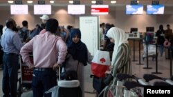 People line up to check in for a flight from Toronto Pearson International Airport to Riyadh, Saudi Arabia, in Toronto, Canada, Aug. 10, 2018. 