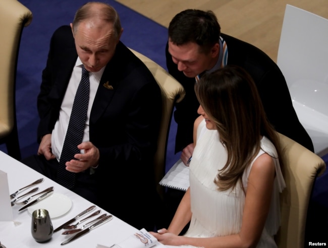 Russia's President Vladimir Putin talks to Melania Trump during the official dinner at the Elbphilharmonie Concert Hall during the G20 summit in Hamburg, Germany, July 7, 2017.