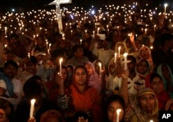 FILE - Pakistani Christians hold candles during a vigil for victims of a suicide bombing in Lahore, Pakistan, March 30, 2016.