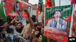 (FILES) Supporters and activists of Pakistan Tehreek-e-Insaf (PTI) party shout slogans during a protest demanding the release of PTI leader Imran Khan, in Peshawar on January 28, 2024.