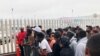 အမေရိကန်-မက္ကဆီကို နယ်စပ်မှာ အမေရိကန်နိုင်ငံတွင်း ခိုလှုံခွင့်ရသူစာရင်း ကြေညာတာကို စောင့်မျှော်နေကြတဲ့ ရွှေ့ပြောင်းနေထိုင်သူများ။ (ဇူလိုင် ၂၈၊ ၂၀၁၉)