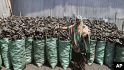 Sacks of dark charcoal sit atop one another in Somalia's southern port city of Kismayo, an industry once worth some $25 million dollar a year to al-Qaida-linked insurgents, Oct. 30, 2012.