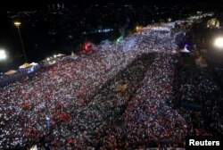 People gather for a ceremony marking the first anniversary of an attempted coup at the Bosporus Bridge in Istanbul, Turkey, July 15, 2017.