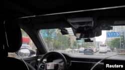 A driverless car by Apollo Go, Baidu's robotaxi service, drives on a road in Wuhan, Hubei province, China, July 19, 2024.