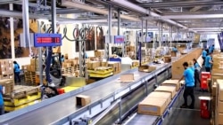 Image taken from video shows people working inside the UNICEF warehouse, the world's largest humanitarian aid warehouse, in Copenhagen, Denmark , Tuesday Oct. 13, 2020.