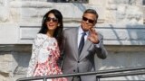 U.S. actor George Clooney and his wife Amal Alamuddin leave the seven-star hotel Aman Canal Grande Venice in Venice, Italy, Sept. 28, 2014.