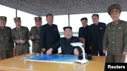 North Korean leader Kim Jong Un (center) inspects a long and medium-range ballistic rocket launch in this undated photo released by North Korea's Korean Central News Agency in Pyongyang on Aug. 30, 2017.