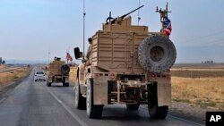  A U.S. military convoy arrives near Dahuk, Iraqi, Monday, Oct. 21, 2019. 