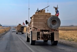 A U.S. military group arrives near Dahuk, Iraq, Monday, October 21, 2019.