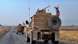 A U.S. military group arrives near Dahuk, Iraq, Monday, October 21, 2019.