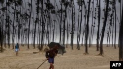 A Bangladeshi villager evacuates to a cyclone shelter on the coast in Cox's Bazar district on May 30, 2017.