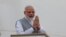 FILE - Indian Prime Minister Narendra Modi greets as he disembarks from the aircraft upon his arrival in Colombo, Sri Lanka, Thursday, May 11, 2017.