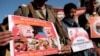 FILE - Houthi supporters hold posters as they attend a demonstration against the United States over its decision to designate the Houthis a foreign terrorist organization in Sanaa, Yemen, Jan. 25, 2021. 