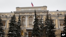 FILE - Russia's Central Bank building in Moscow, Russia, Friday, Jan. 30, 2015. US announced tough new economic measures against Russia Thursday. (AP Photo/Alexander Zemlianichenko)