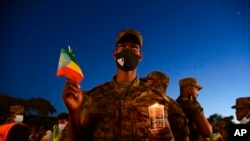 FILE - Current and former Ethiopian military personnel and the public commemorate federal soldiers killed by forces loyal to the Tigray People's Liberation Front at the start of the conflict one year ago, at a candlelit event outside the city administrati