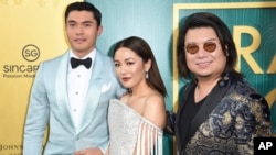 Henry Golding, from left, Constance Wu and executive producer/author Kevin Kwon arrive at the premiere of "Crazy Rich Asians" at the TCL Chinese Theatre, Aug. 7, 2018, in Los Angeles.