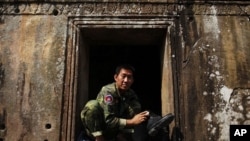 A Cambodian soldier polishes his boots at the 11th-century Preah Vihear temple on the border between Thailand and Cambodia, February 8, 2011
