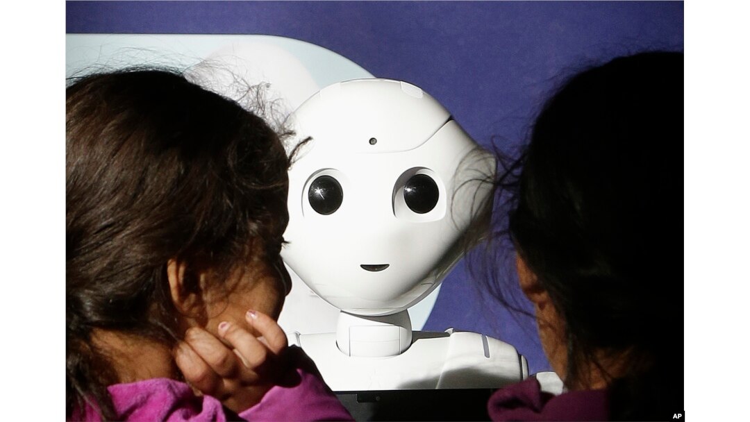 Two young sisters get to know Pepper the robot at Westfield Mall in San Francisco, Dec. 22, 2016.
