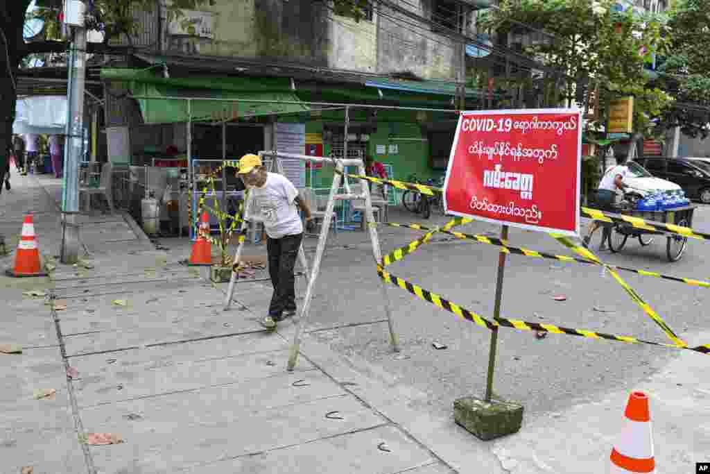 ကို႐ိုနာဗုိင္းရပ္စ္ ကူးစက္ပ်ံ႔ႏွံ႔မႈ တုိးေနတဲ့ ရန္ကုန္ၿမိဳ႕မွာ အဝင္အထြက္ ကန္႔သတ္ပိတ္ဆုိ႔ထားတဲ့ လမ္းတခုအနီး ျဖတ္သြားတဲ့ ေဒသခံတဦး။ (စက္တင္ဘာ ၁၁၊ ၂၀၂၀)