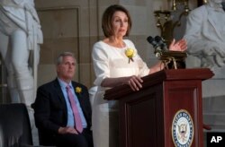 Speaker of the House Nancy Pelosi, D-Calif., and House Republican Leader Kevin McCarthy, D-Calif., left, appear together at an event to commemorate the 100th anniversary of the 19th Amendment in Washington, Tuesday, May 21, 2019.