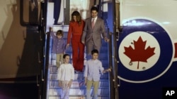 Prime Minister Justin Trudeau, his wife, Sophie Gregoire Trudeau, their sons Hadrien and Xavier, daughter Ella-Grace walk down an airstair upon their arrival at the Palam Air Force Station in New Delhi, India, Feb. 17, 2018.