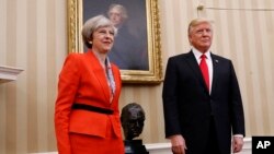 President Donald Trump stands with British Prime Minister Theresa May in the Oval Office of the White House in Washington, Jan. 27, 2017.