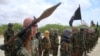 FILE - Al-Shabab fighters display weapons as they conduct military exercises in northern Mogadishu, Somalia, Oct. 21, 2010.