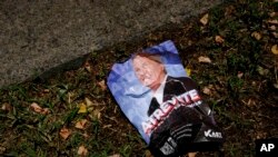 A political propaganda flyer of presidential candidate Jose Antonio Kast of the Republican Party lies discarded on the ground in Santiago, Chile, Dec. 7, 2021.