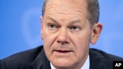 FILE - German Federal Chancellor Olaf Scholz speaks at the Federal Chancellery in Berlin, Dec. 21, 2021.