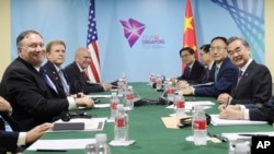 U.S. State Secretary Mike Pompeo, left, and China's Foreign Minister Wang Yi, right, at a bilateral meeting on the sidelines of the 51st ASEAN Foreign Ministers Meeting in Singapore, Aug. 3, 2018.