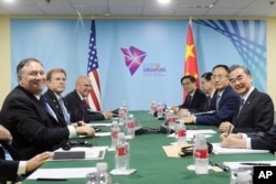 U.S. State Secretary Mike Pompeo, left, and China's Foreign Minister Wang Yi, right, at a bilateral meeting on the sidelines of the 51st ASEAN Foreign Ministers Meeting in Singapore, Aug. 3, 2018.