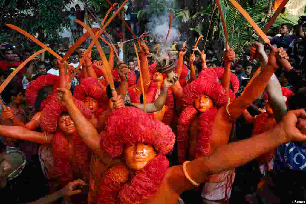 Hindu devotees dance on the street as they celebrate Lal Kach festival in Narayanganj, Bangladesh.