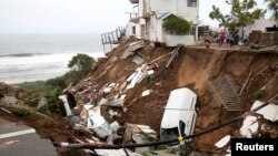 Vehicles and debris are scattered after massive flooding in Amanzimtoti, near Durban, South Africa, April 24, 2019. 