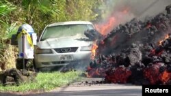 Lava engulfs a Ford Mustang in Puna, Hawaii, May 6, 2018.