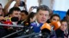 FILE - Ukrainian President Petro Poroshenko (C), a presidential candidate at the time, speaks to journalists in Kyiv, May 25, 2014. Recently, Poroshenko has raised eyebrows urging journalists not to write “negative articles about Ukraine.” 
