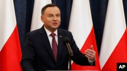 Poland's President Andrzej Duda tells a news conference he has decided to sign two laws that will put courts under more political control even though they are part of a review a concerned European Union is conducting in Warsaw, Poland, Dec. 20, 2017. 