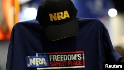 FILE - A cap and shirt are displayed at the booth for the National Rifle Association (NRA) at the Conservative Political Action Conference (CPAC) at National Harbor, Maryland, U.S., Feb. 23, 2018. 