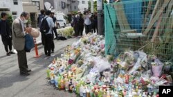 A man prays for victims at the site where a knife attack took place in Kawasaki near Tokyo, Japan, May 29, 2019. 