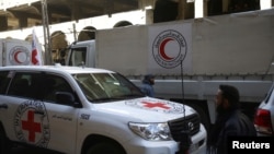 International Red Cross (CIRC) and Red Crescent aid trucks are seen in the besieged town of Douma, eastern Ghouta, in Damascus, Syria, March 9, 2018.