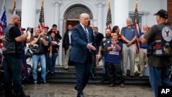 President Donald Trump greets members of Bikers for Trump and supporters, Saturday, Aug. 11, 2018, at the clubhouse of Trump National Golf Club in Bedminster, N.J.