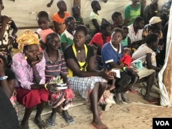 New refugee arrivals from South Sudan wait to register at the Imvempi reception center in Arua district, Uganda, Jan. 30, 2018. (H. Athumani/VOA)