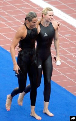 FILE - Germany's Britta Steffen, right, walks off with Dara Torres of the United States after winning a women's 50-meter freestyle final at the FINA Swimming World Championships in Rome, Aug. 2, 2009. Swimsuit design wars culminated with a ludricrous display of speed at the 2009 championships.