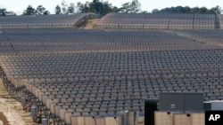 Looking like a vineyard, 206,000 polycrystalline solar panels make up the 540-acre site solar project in Lamar County near Sumrall, Miss., Wednesday, March 7, 2018. (AP Photo/Rogelio V. Solis)