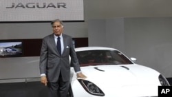 Chairman of Tata Group Ratan Tata poses with Jaguar's newly launched C-X16 car during India's Auto Expo, in New Delhi January 5, 2012.