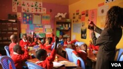 A teacher at the Kibera School for Girls teaches students about shapes in Nairobi, Kenya, March 19, 2013. (J. Craig/VOA)